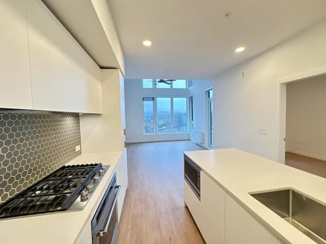 Kitchen featuring white cabinetry, modern cabinets, appliances with stainless steel finishes, light wood-style flooring, and recessed lighting