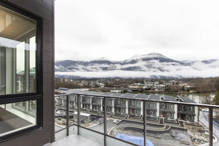 Balcony featuring a water and mountain view