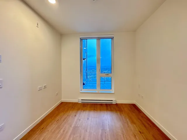 Spare room with light wood-style floors and a baseboard heating unit