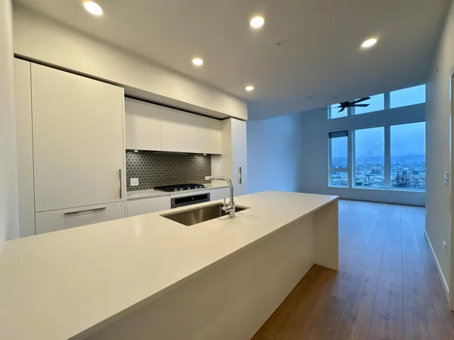 Kitchen with modern cabinets, white cabinetry, ceiling fan, recessed lighting, and dark wood-style flooring