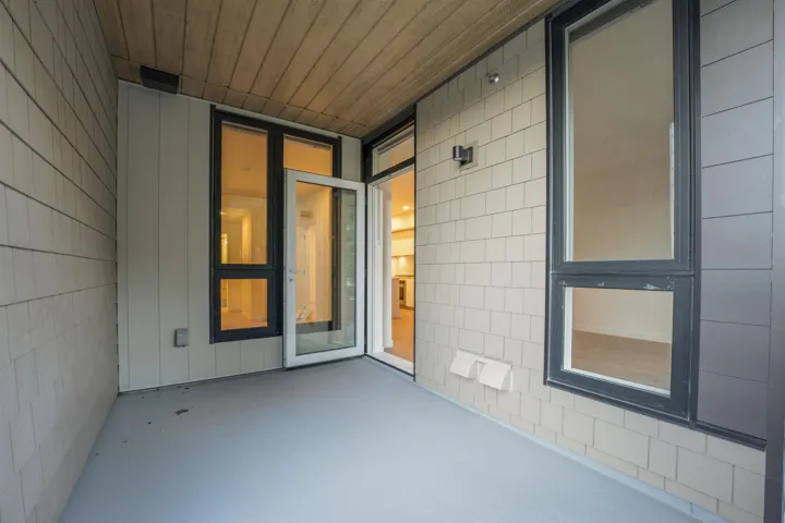 Private outdoor patio featuring a painted concrete floor, wood-finish ceiling, and shingle-style siding