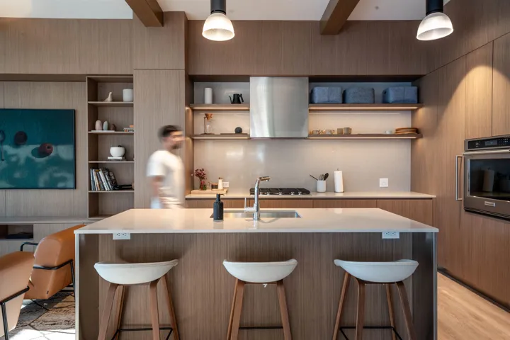 Modern kitchen island featuring a light-toned countertop and integrated sink