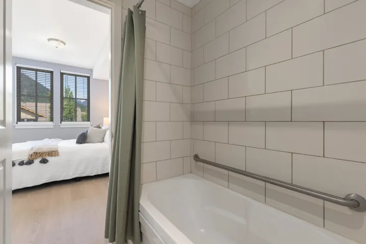 Shower-over-tub design with subway tile surround and a grab bar