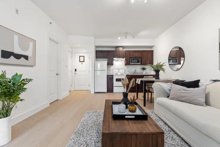 Open-concept living space featuring wood-finish flooring