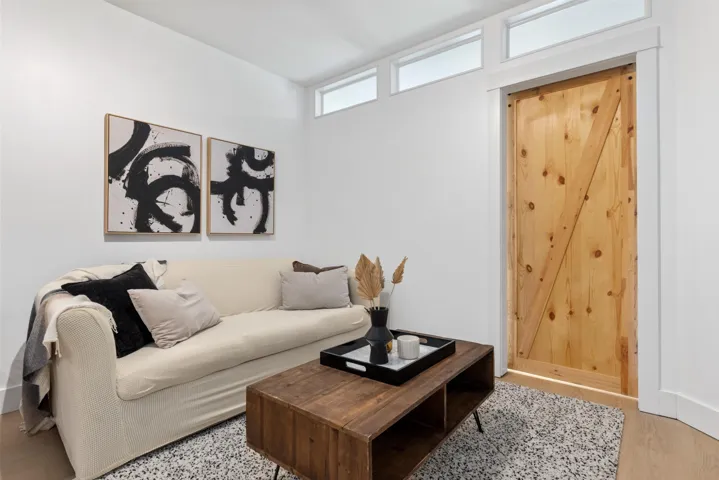 Natural wood barn door with white trim, complemented by transom windows