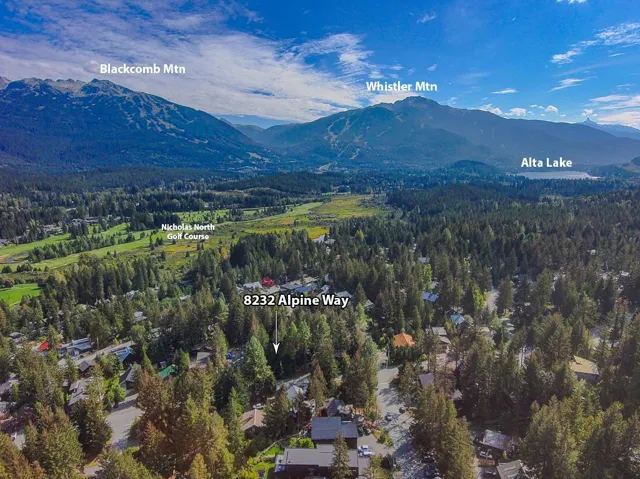 Aerial view of property's location with mountains and a forest