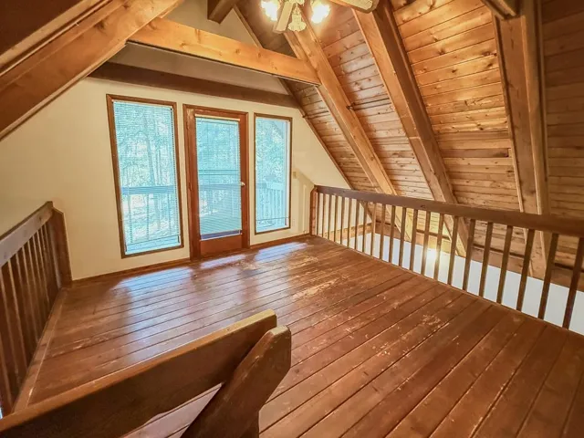 Additional living space featuring a ceiling fan, wood-type flooring, and wood ceiling