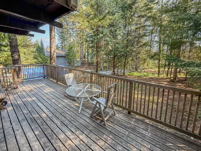 Wooden deck with view of scattered trees
