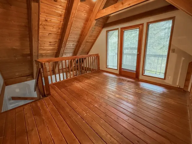 Additional living space featuring hardwood / wood-style flooring and wooden ceiling