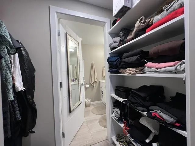 Custom closet organization system featuring multiple shelves for storage