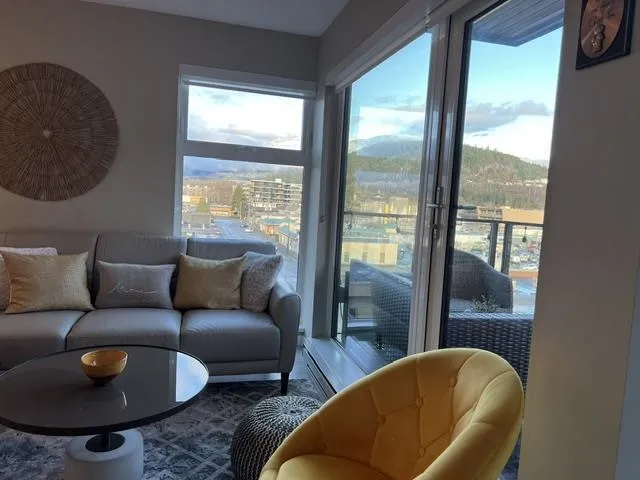 Expansive window wall with a sliding glass door leading to a balcony