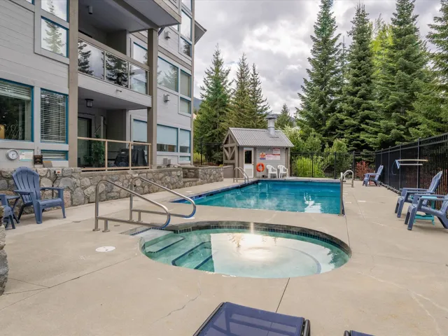 Community pool with a community hot tub and a patio