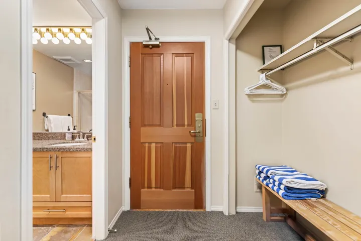 Entrance foyer featuring carpet flooring and baseboards