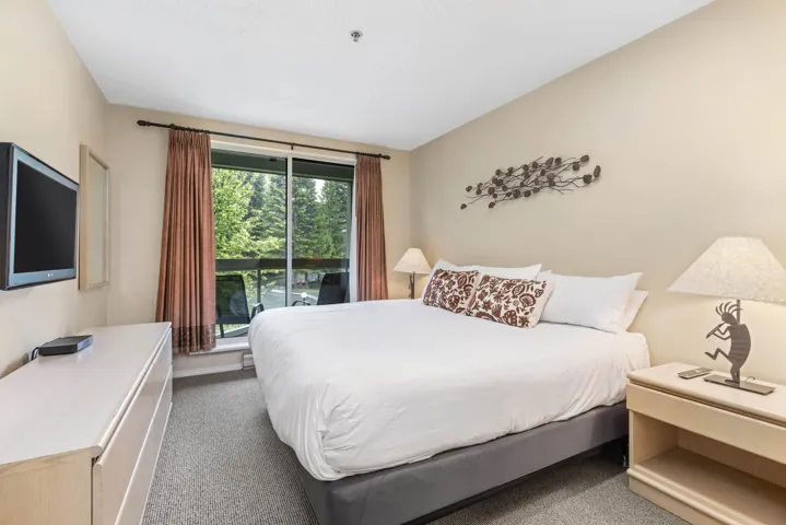 Bedroom with carpet floors, access to exterior, and baseboards