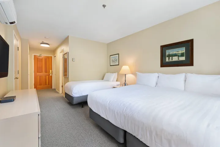 Carpeted bedroom with an AC wall unit