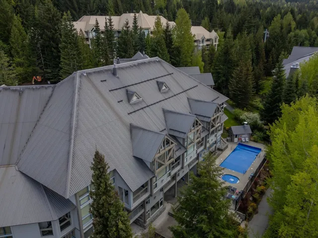 View from above of property with a forest and a pool