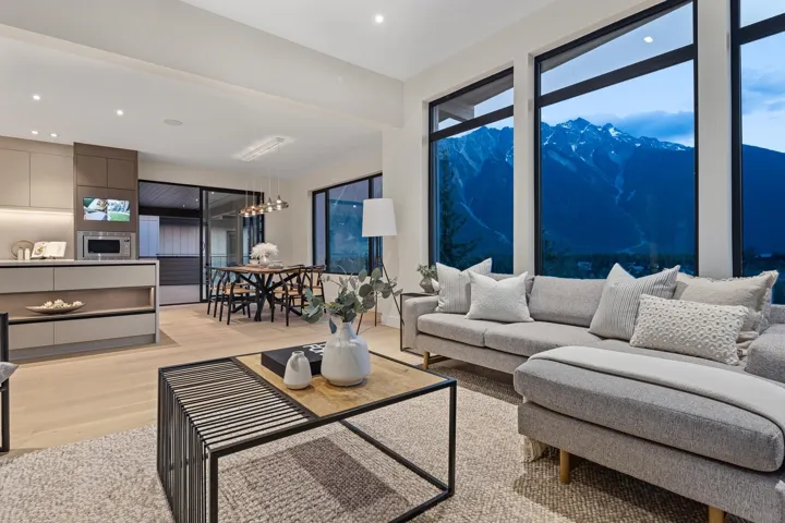 Living area featuring a mountain view, light wood-style flooring, recessed lighting, and a chandelier