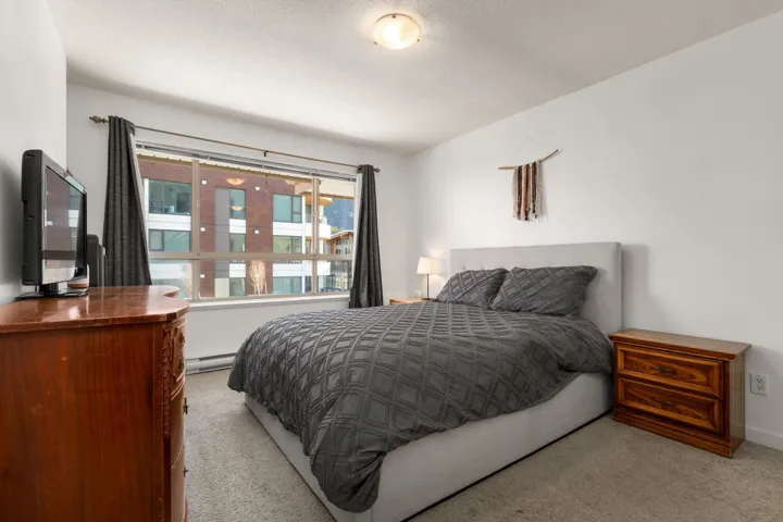Carpeted bedroom with baseboard heating