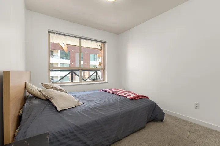 Carpeted bedroom featuring baseboards