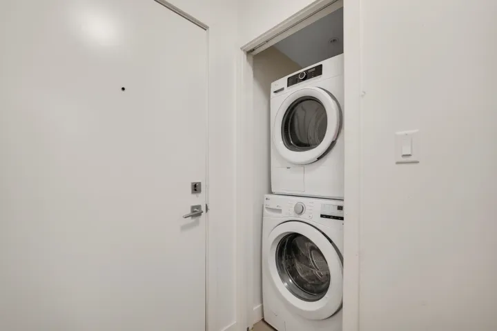 Laundry area featuring stacked washer / drying machine