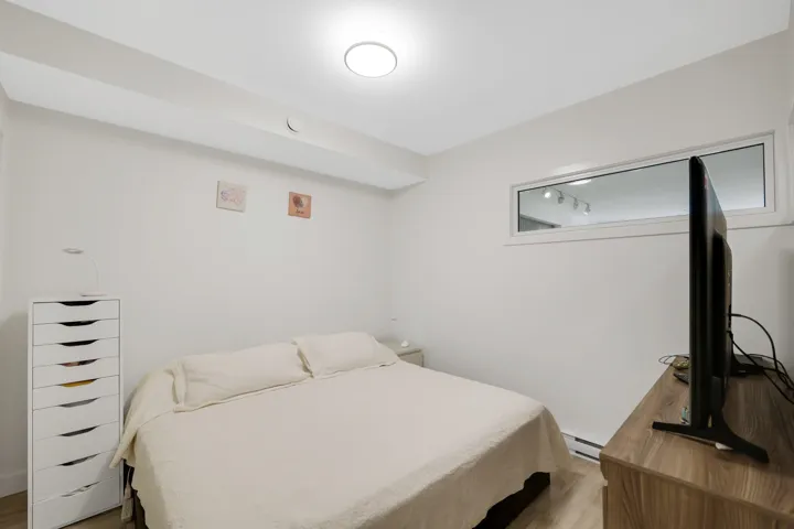 Bedroom featuring wood finished floors and a baseboard radiator