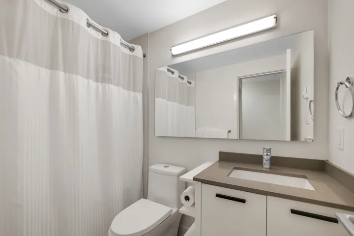 Full bath featuring vanity and curtained shower