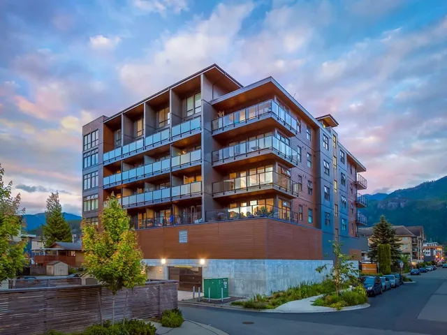 Property at dusk featuring a view of apartment building / complex and a mountain view