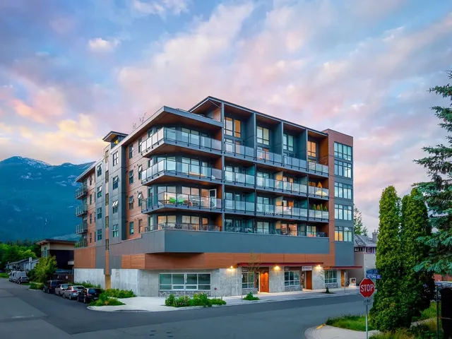 Property at dusk with a view of apartment building / complex and a mountain view