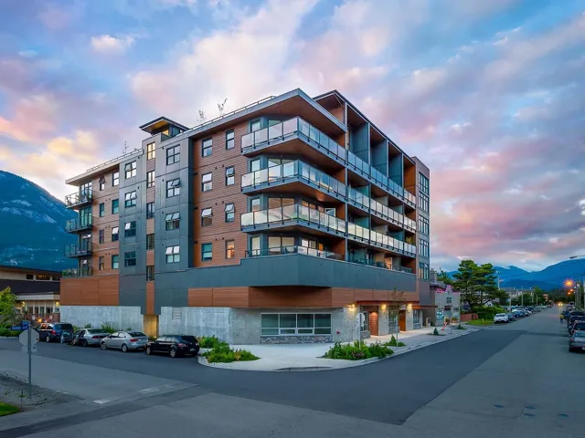Property at dusk featuring a mountain view and a view of apartment building / complex