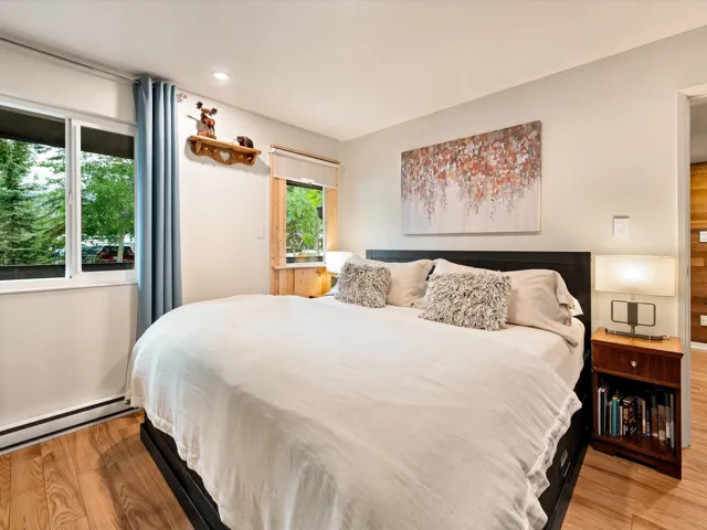 Bedroom featuring baseboard heating, wood finished floors, and recessed lighting
