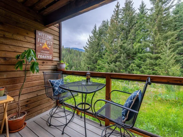 Balcony featuring a wooded view