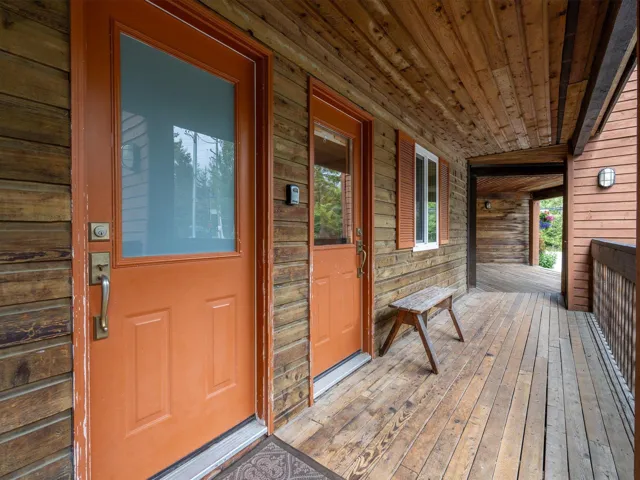 Entrance to property featuring covered porch