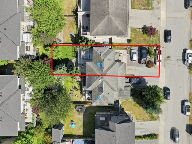 Aerial perspective showcasing the property's roofline, ample parking, and spacious rear yard