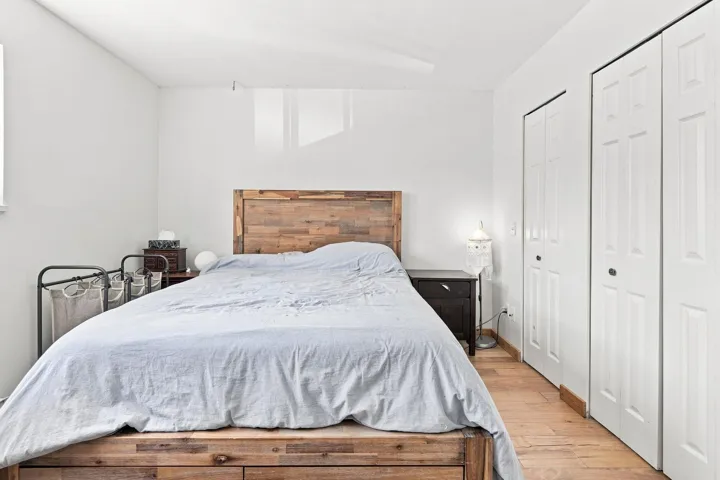 Room featuring wood-finish flooring and bright white walls