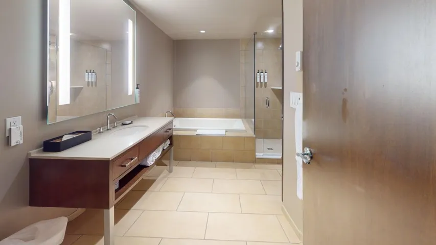 Bathroom with light tile patterned floors, a garden tub, vanity, and a stall shower