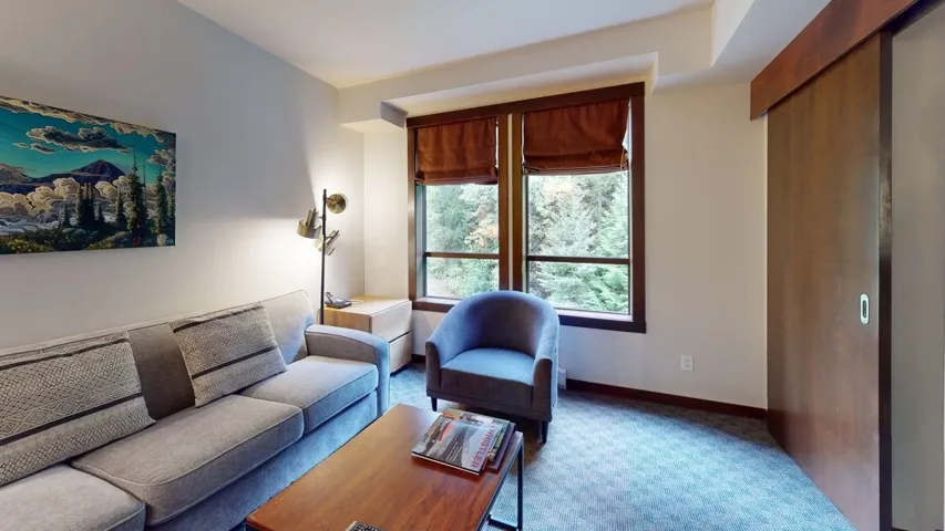 Living area with carpet flooring and baseboards