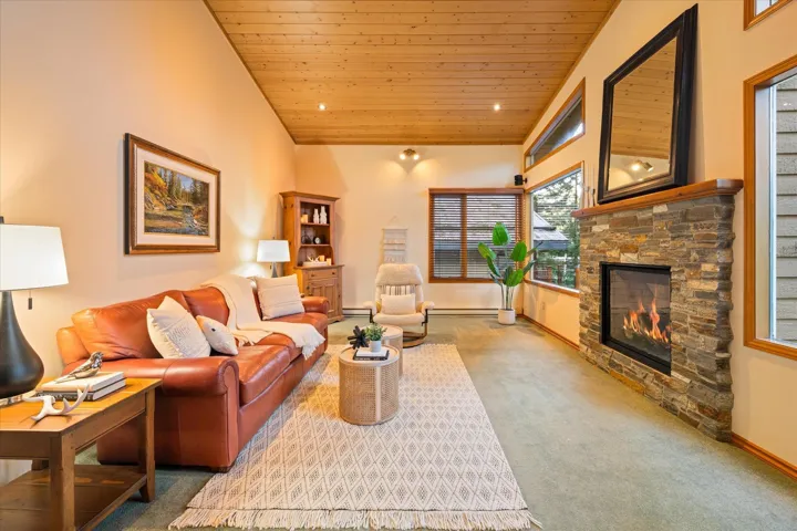 Living room featuring carpet, wood ceiling, a fireplace, recessed lighting, and baseboard heating
