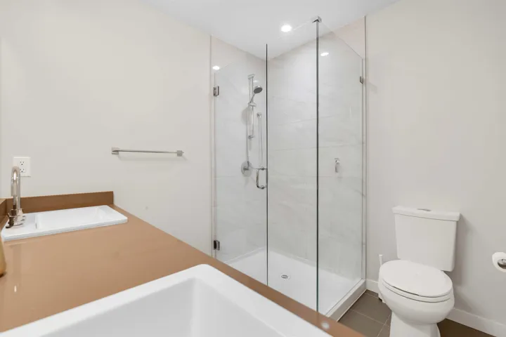 Bathroom with a shower stall and tile patterned floors