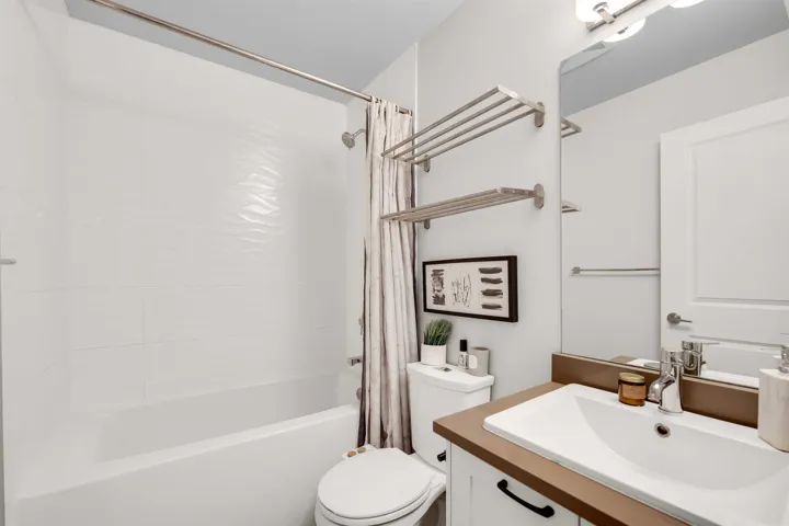 Bathroom featuring shower / bath combination with curtain and vanity