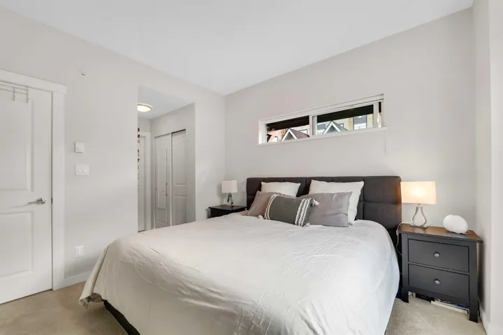 Bedroom featuring light carpet and a closet