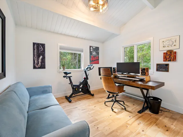 Office area featuring light wood-style floors, healthy amount of natural light, a baseboard radiator, and wood ceiling