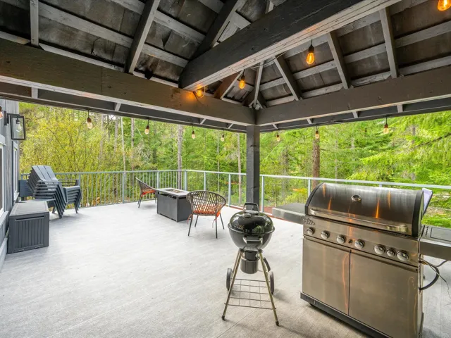 View of patio / terrace featuring area for grilling, an outdoor fire pit, and view of wooded area