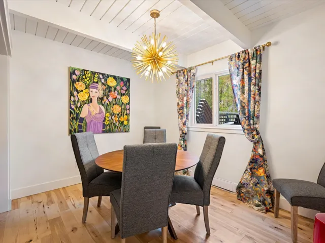 Dining room featuring a chandelier, wood-type flooring, and a wood ceiling with exposed beams