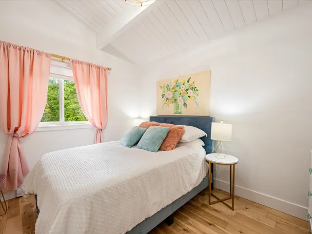 Bedroom with light wood-type flooring and wooden ceiling