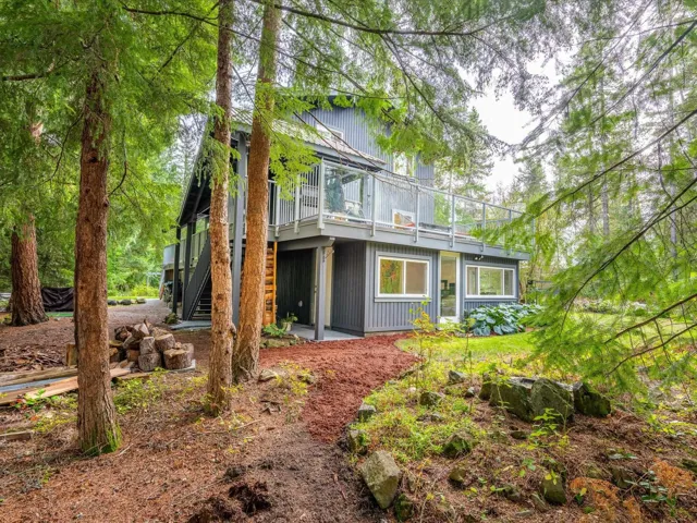 Rear view of house featuring a patio, stairs, and a wooden deck
