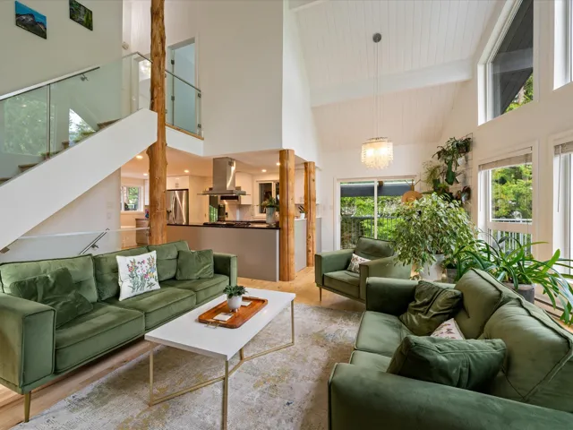 Building lobby featuring high vaulted ceiling, stairs, and a wooden ceiling with exposed beams