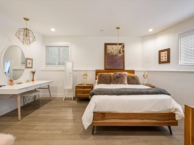 Bedroom with a chandelier, light wood-style flooring, recessed lighting, and multiple windows