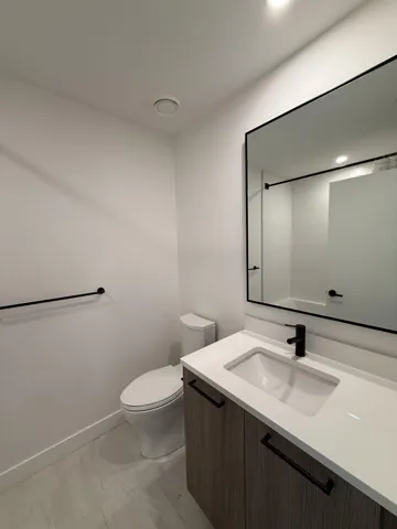 Bathroom with vanity, recessed lighting, toilet, marble finish floor, and baseboards