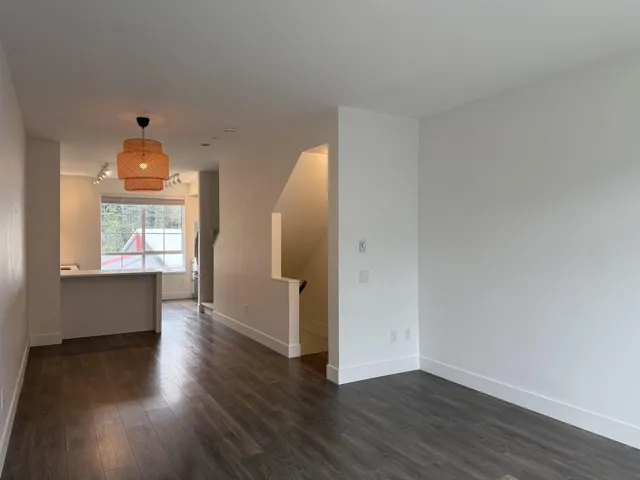 Unfurnished living room with baseboards and dark wood finished floors