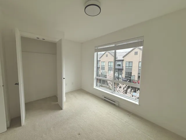 Unfurnished bedroom with baseboards and carpet
